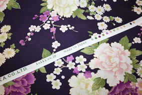 Japansk bomuldsstof fra Kokka “Wagara” med lilla og hvide pæoner, sakura-blomster og metalliske gulddetaljer på mørkelilla bund